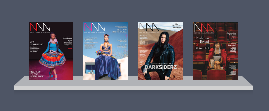 Four past issues of Native Max Magazine on a shelf