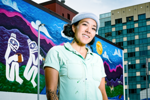 Worl with her mural in Anchorage, courtesy of Worl & Charles Tice