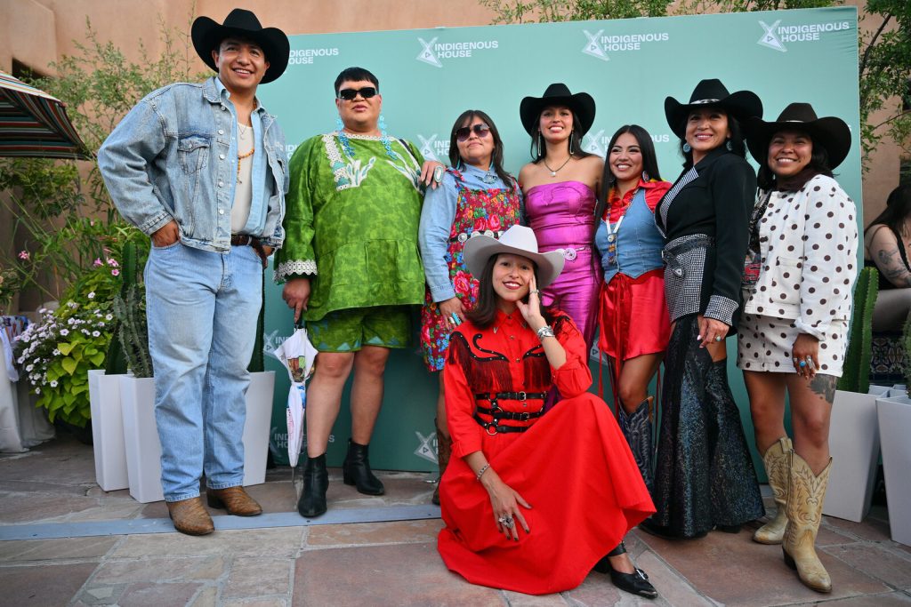Guests pose with Indigenous House creative director Peshawn Bread at the Rez Roundup Honky Tonk.