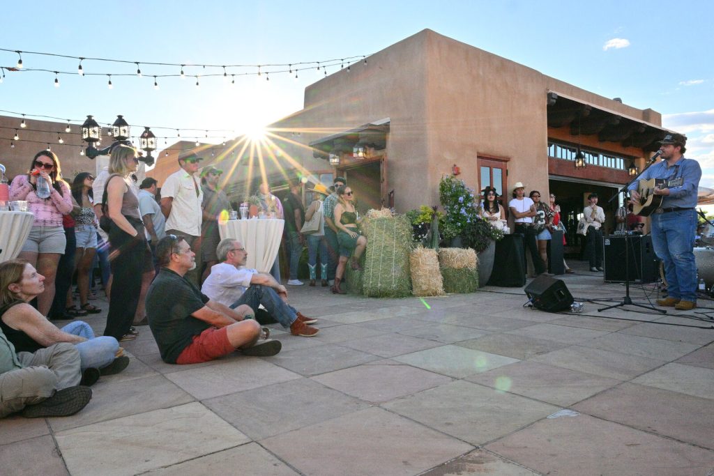 Vincent Neil Emerson performs at the Rez Roundup Honky Tonk as guests watch at golden hour