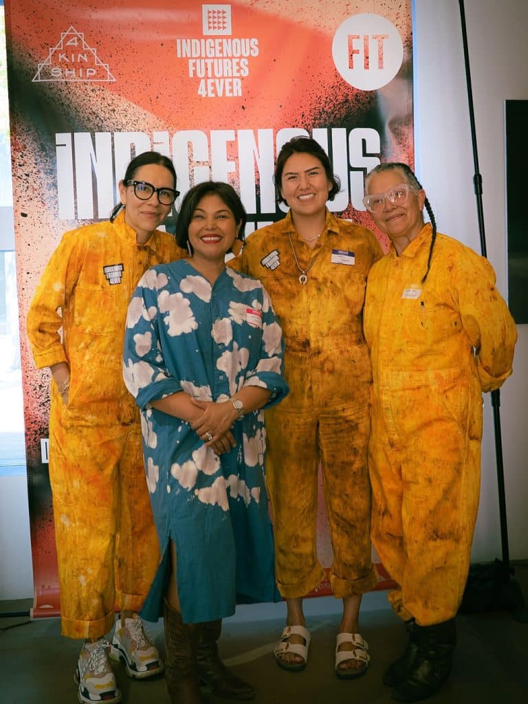 Amy Denet Deal and guests pose in front of the Indigenous Fashion 4EVER backdrop at the Santa Fe Art Institute. Photo by The Berry Pickers.
