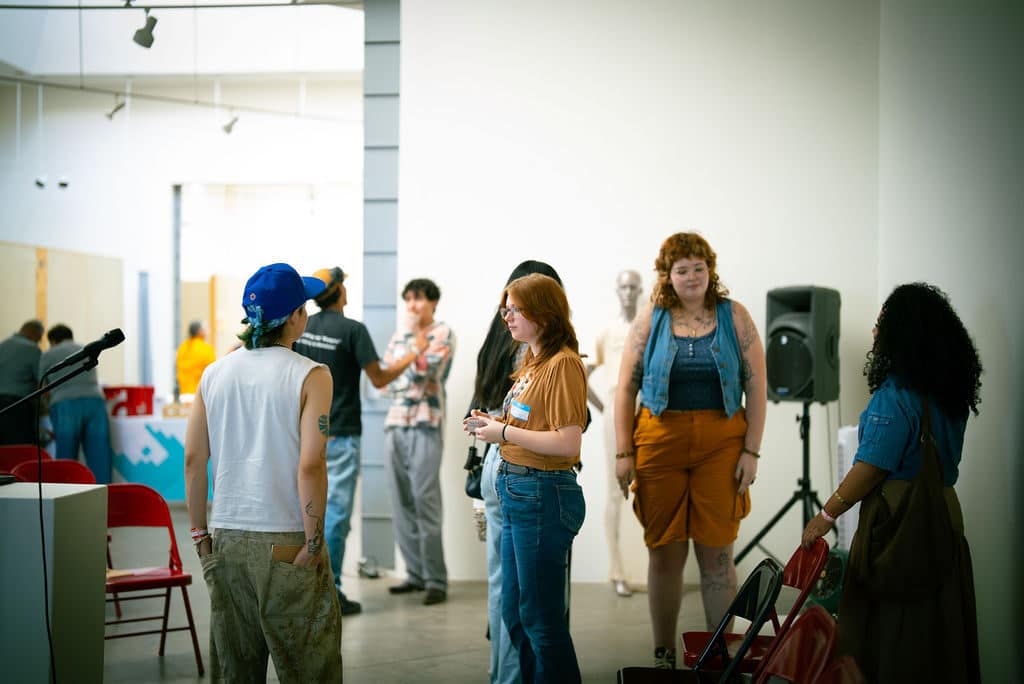 Guests mingle in the gallery at the Santa Fe Art Institute during Indigenous Fashion 4EVER. Photo by The Berry Pickers.