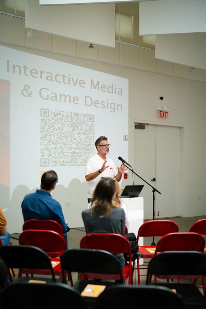 An FIT faculty member presents an Interactive Media and Game Design slide to students