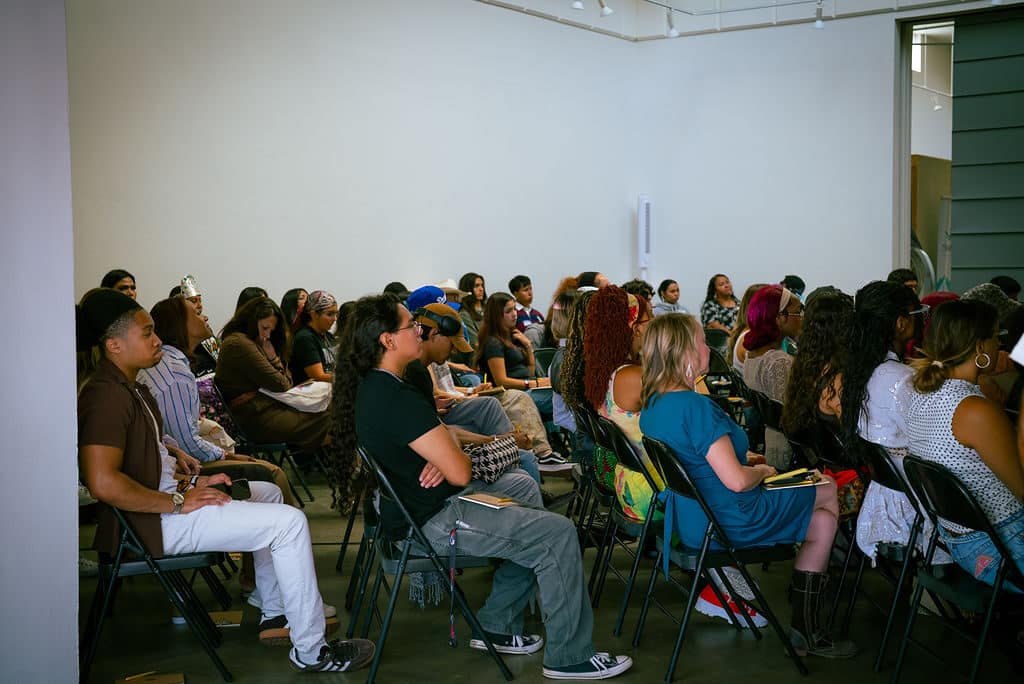 Students and chaperones seated for the Indigenous Fashion 4EVER morning program
