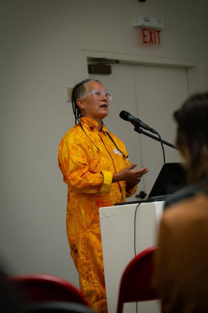 Amy Denet Deal speaks from the podium during Indigenous Fashion 4EVER