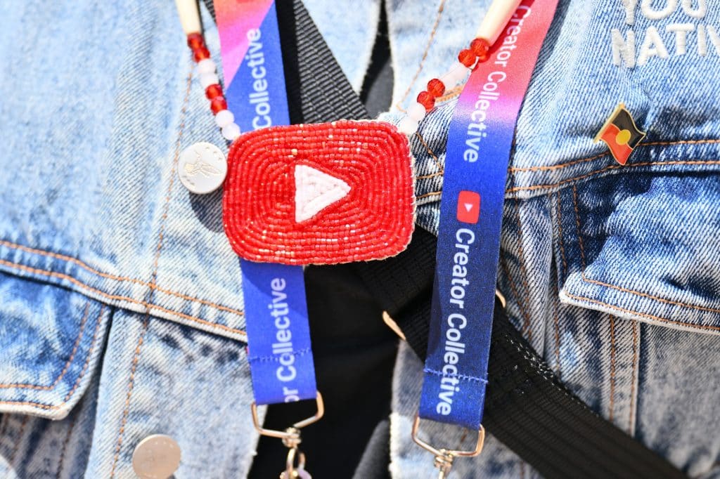 A guest displays a beaded YouTube logo during the Indigenous House Indigenous Creator's Summit on August 14, 2026 in Santa Fe, New Mexico.