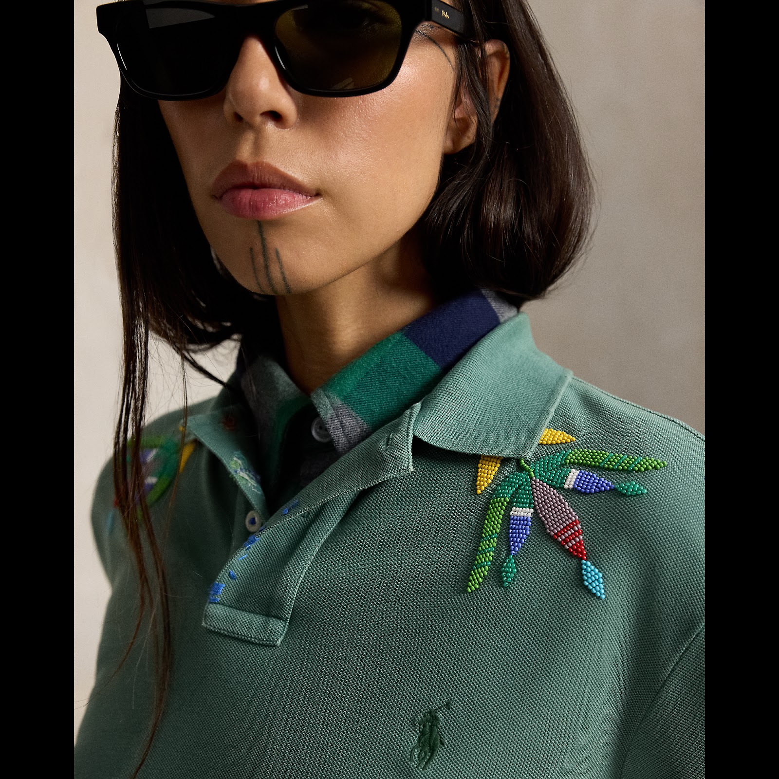 Quannah ChasingHorse wearing the Strong Sage Polo Shirt.
